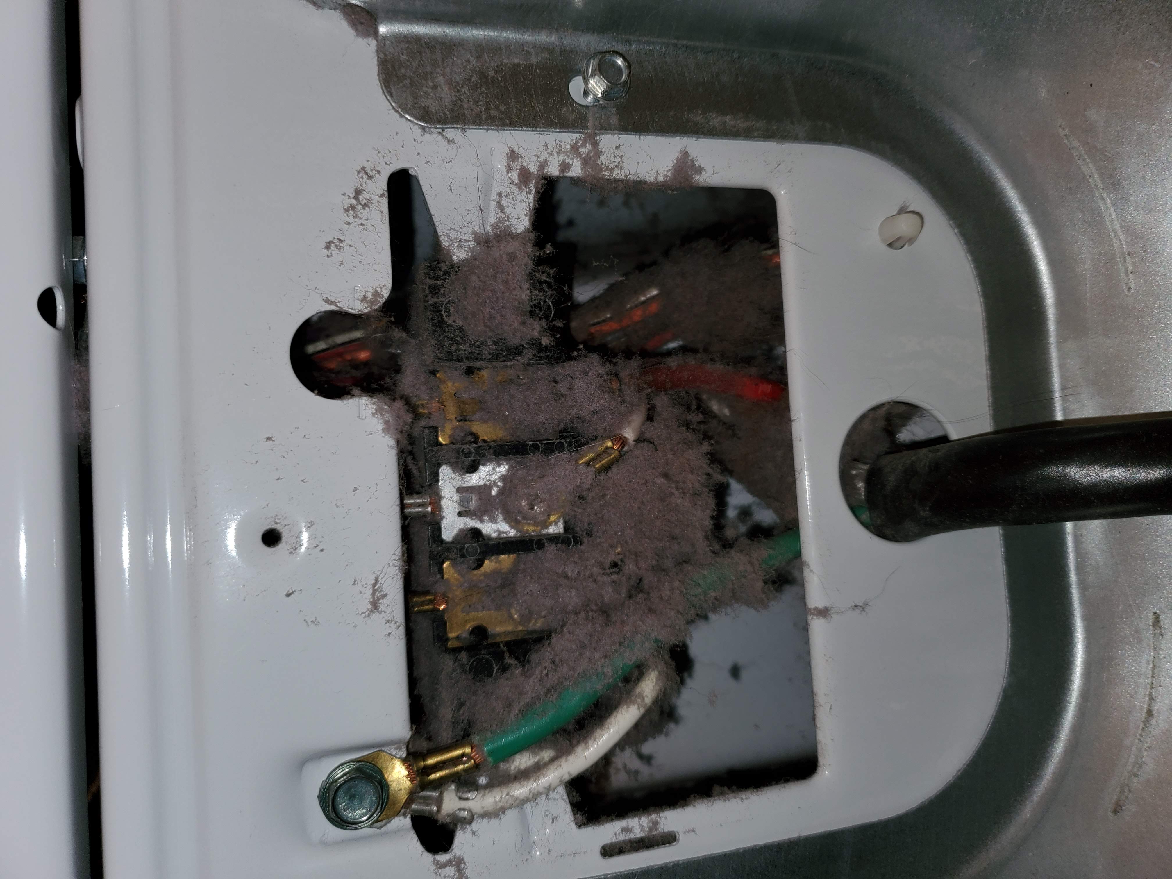 Lint packed around dryer power cord and electrical connection
