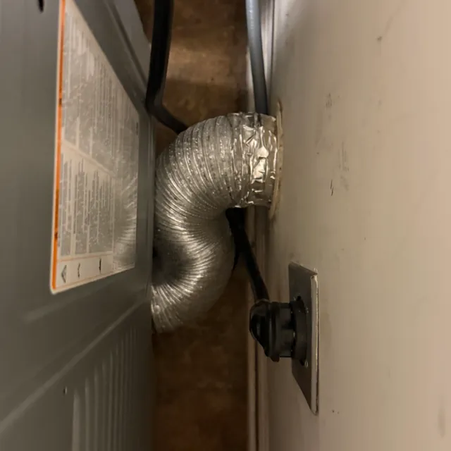DryerFlex transition hose air-sealed from dryer exhaust to wall with clean laundry room floor