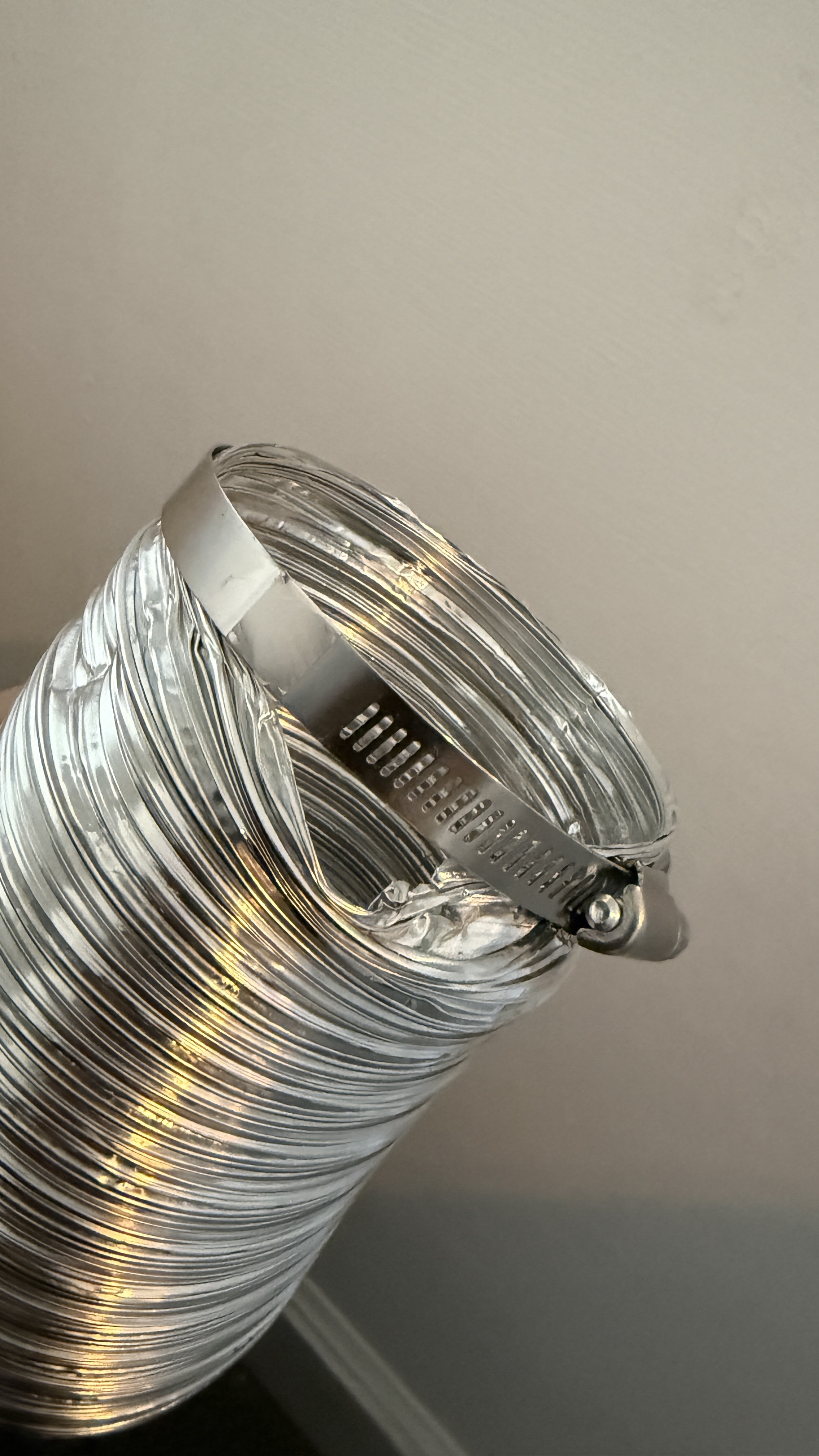 Gap at dryer vent hose clamp allowing lint to leak into the laundry room