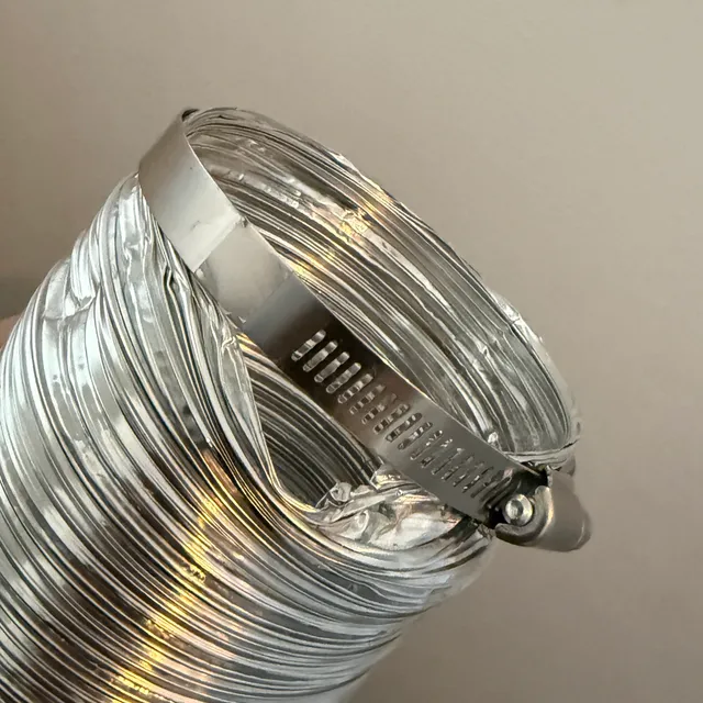 Gap at dryer vent hose clamp allowing lint to leak into the laundry room