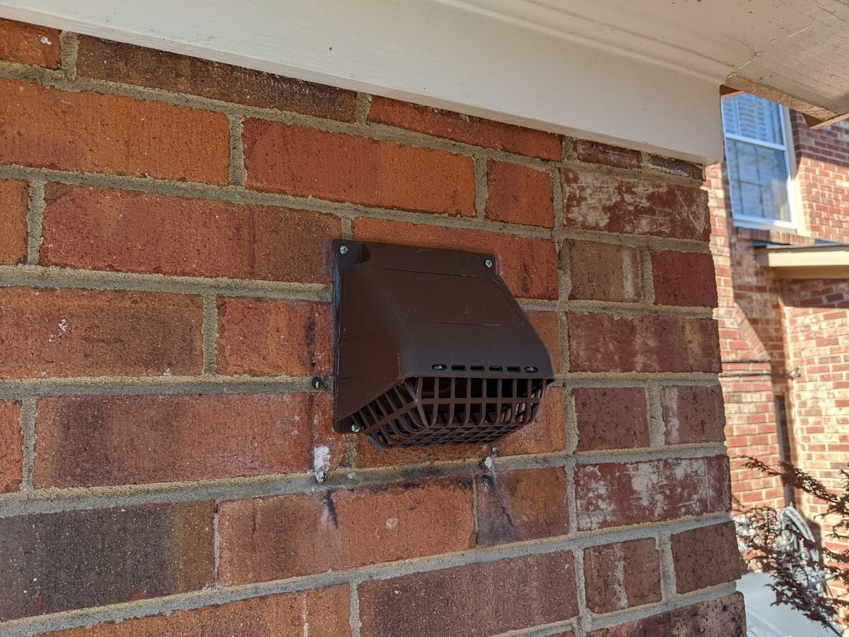 Plastic vent cap on home exterior
