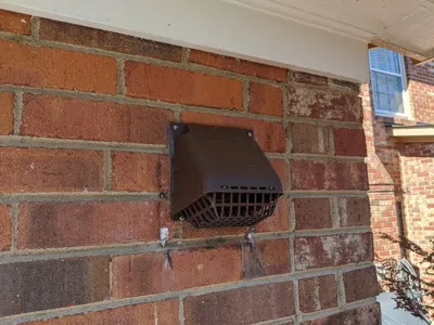 Plastic vent cap on home exterior