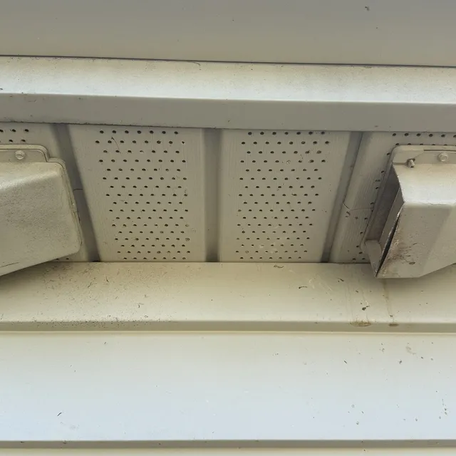 Broken bathroom soffit vent covers where birds and wasps were nesting in Burlington NC