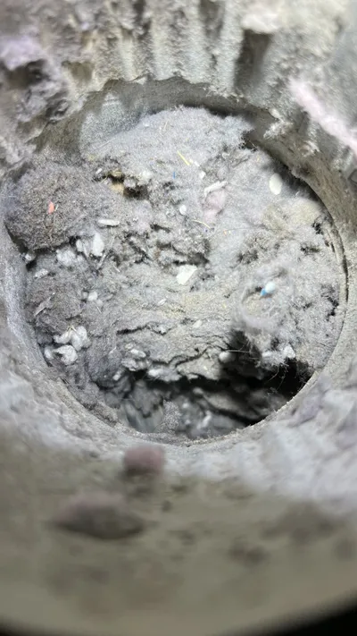 Clogged dryer vent pipe packed with lint in a Burlington NC home