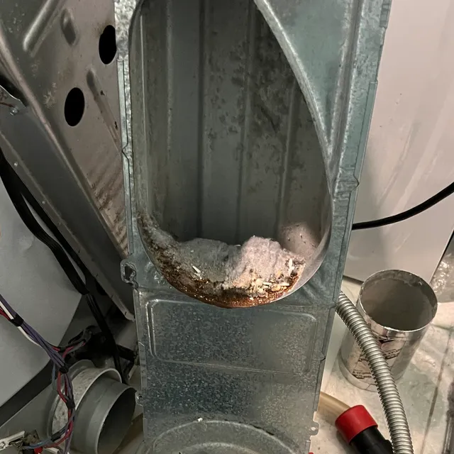Lint in the lint trap housing and intake of a dryer at Friendly Acres Townhomes