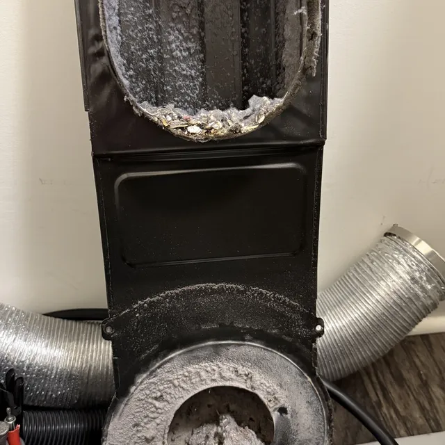 Clogged lint trap housing inside a Whirlpool dryer in Reedy Fork Ranch Greensboro