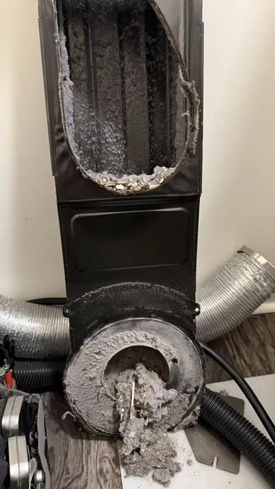 Clogged lint trap housing inside a Whirlpool dryer in Reedy Fork Ranch Greensboro