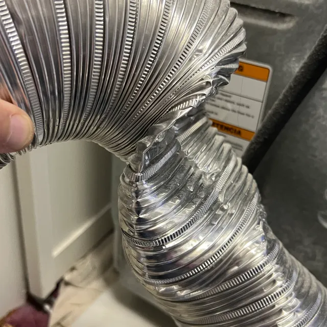Crushed semi-rigid dryer transition hose restricting airflow