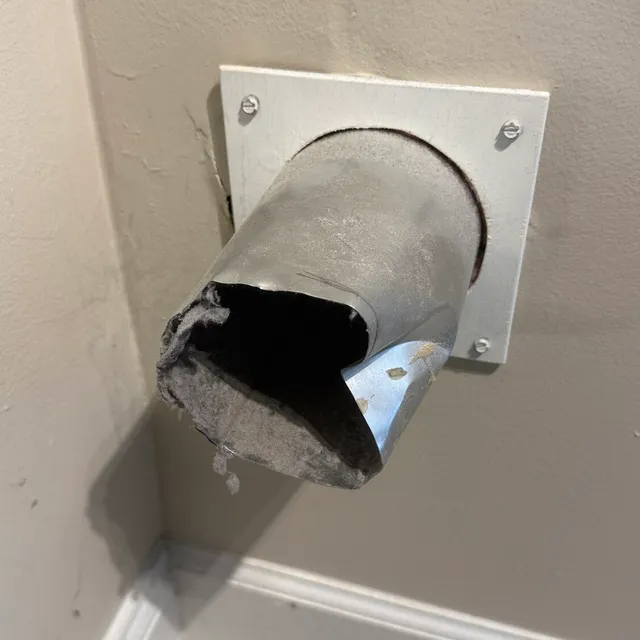 Crushed metal dryer vent stub from an overtightened clamp in Sunset Hills Greensboro