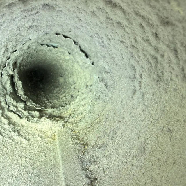 Dirty dryer vent pipe coated with lint in Old Irving Park