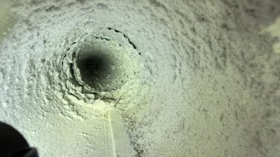Dirty dryer vent pipe coated with lint in Old Irving Park