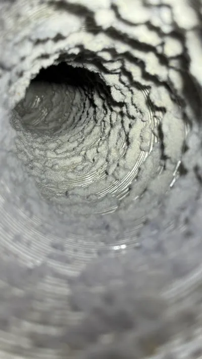 Felted lint coating the inside of a dirty dryer vent in Sunset Hills Greensboro