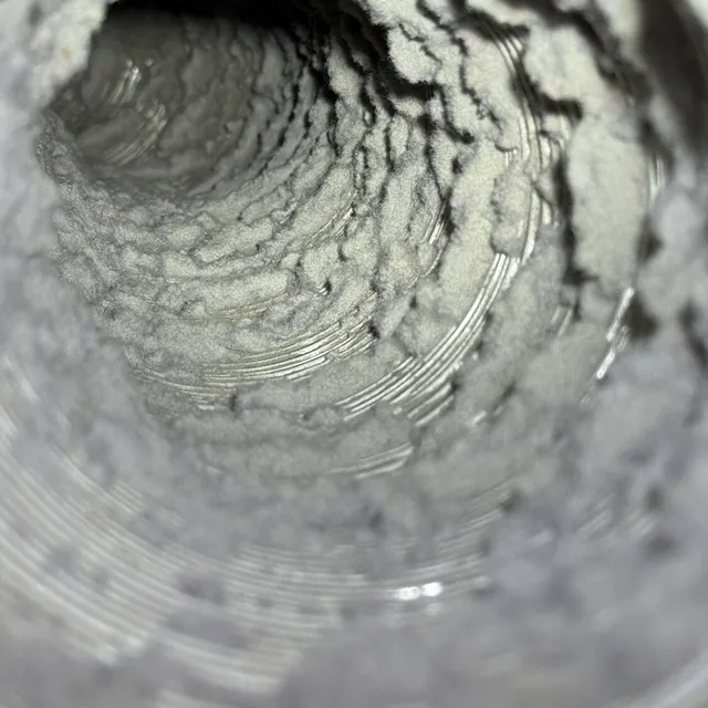 Felted lint coating the inside of a dirty dryer vent in Sunset Hills Greensboro