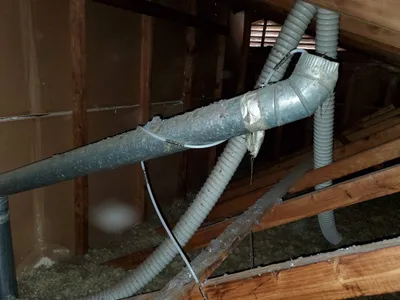 Dryer vent disconnected from roof in attic