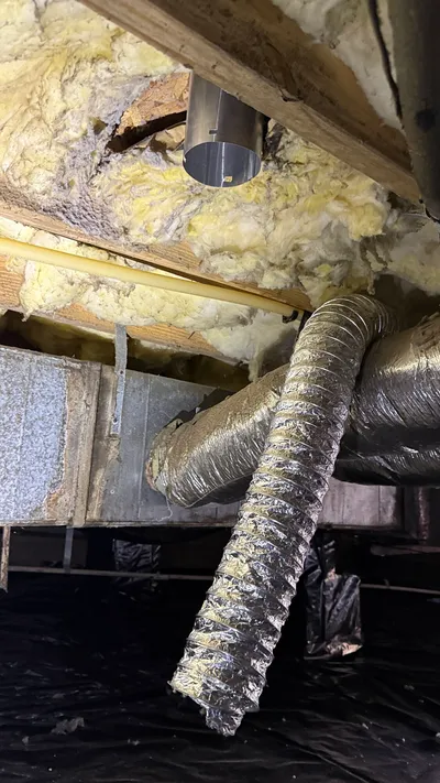 Disconnected dryer vent flex blowing into a Creekridge Eden crawlspace