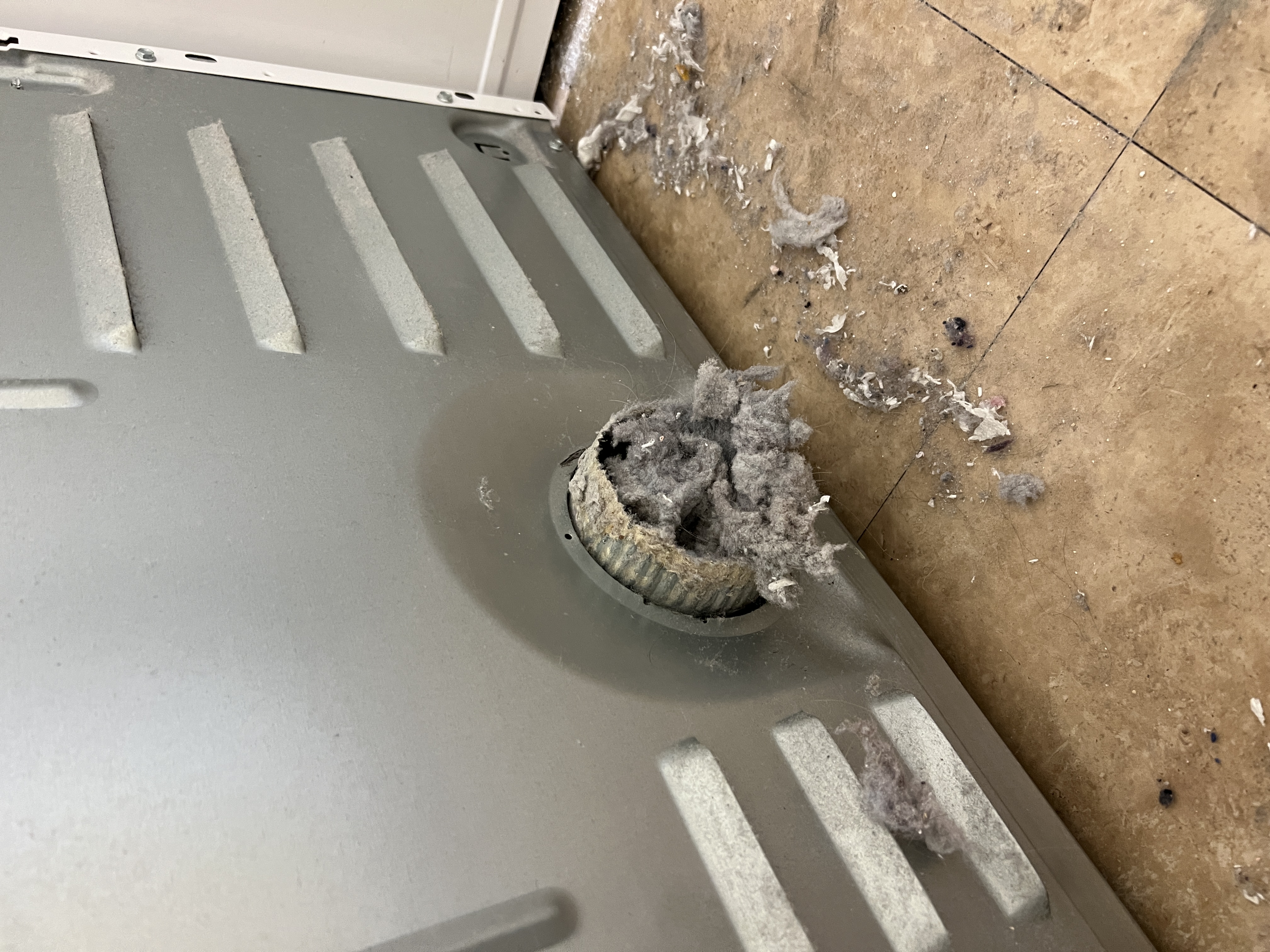 Lint backup at dryer exhaust path inside the machine