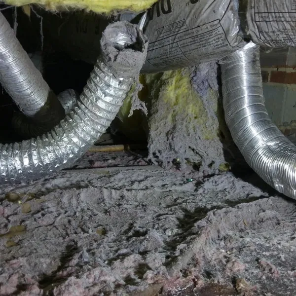 Broken flex vent with lint in crawlspace