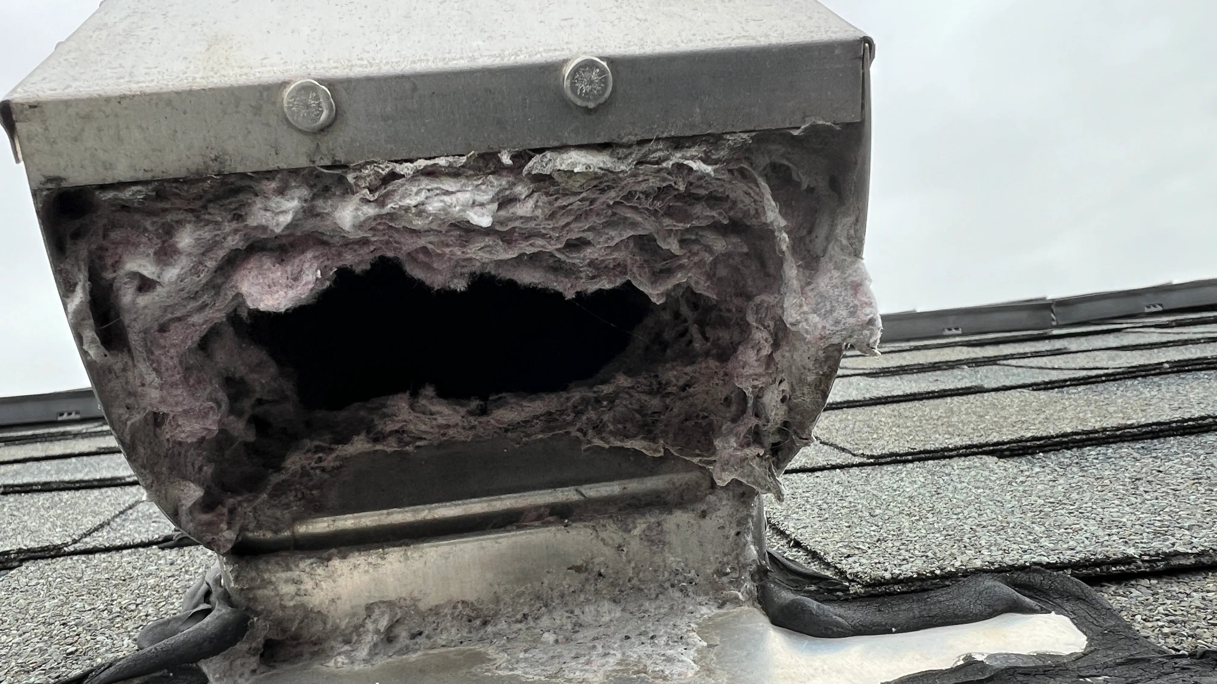 Heavy lint buildup on roof vent Stone Mill Village