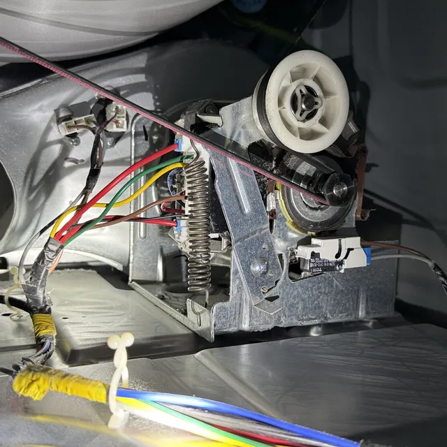 Inside a dryer cabinet around the motor during a Mackintosh on the Lake dryer vent cleaning
