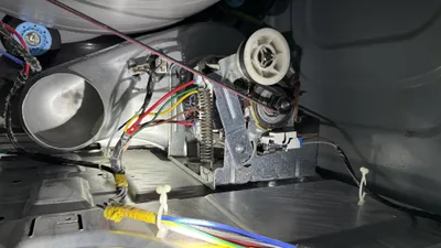 Inside a dryer cabinet around the motor during a Mackintosh on the Lake dryer vent cleaning
