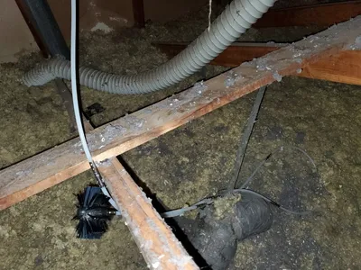 Lint eater brush stuck and tangled in attic