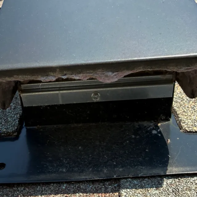 Clean metal dryer vent hood on a west Greensboro roof