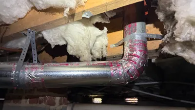 New metal dryer vent turn sealed with mastic and metal straps in a New Irving Park crawlspace