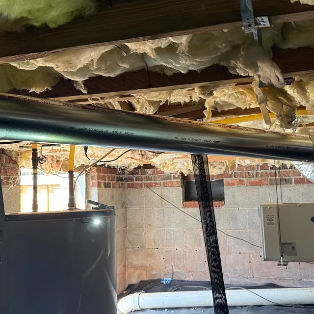 Long-radius metal dryer vent routed away from water heater and humidifier in Eden
