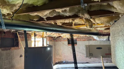 Long-radius metal dryer vent routed away from water heater and humidifier in Eden