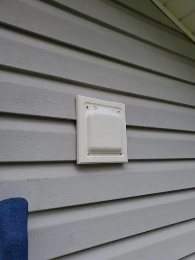 No-pest dual flap vent cap on vinyl siding