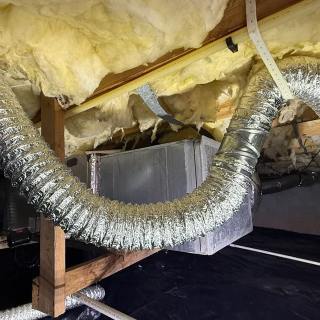 Sagging foil flex dryer vent on plastic hangers in a Creekridge crawlspace