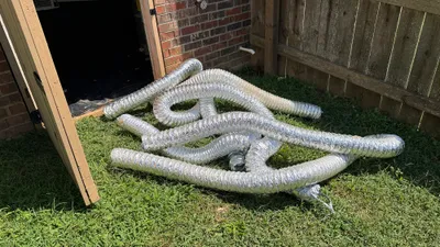 Old flex dryer vent pulled from a Creekridge Eden crawlspace and laid on the lawn