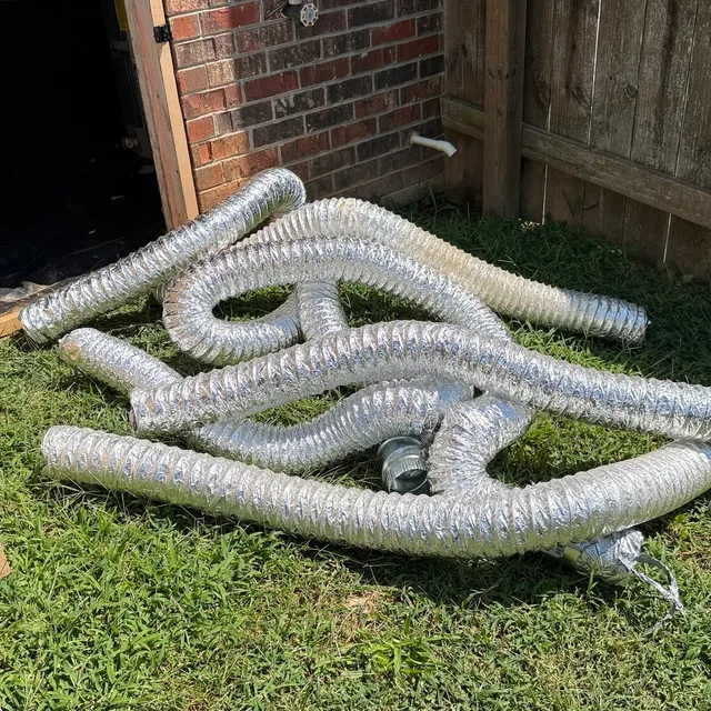 Old flex dryer vent pulled from a Creekridge Eden crawlspace and laid on the lawn