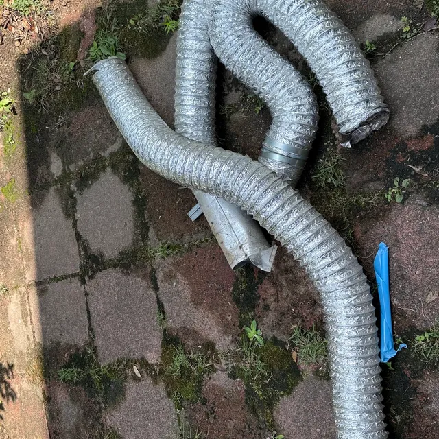 Foil flex dryer vent pulled from a New Irving Park crawlspace and laid on the walk