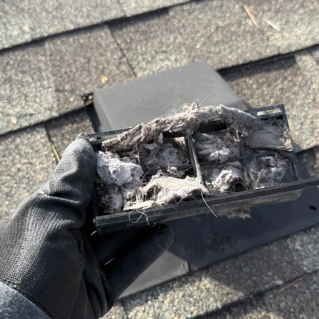Lint packed in a roof vent damper from a nearby west Greensboro job
