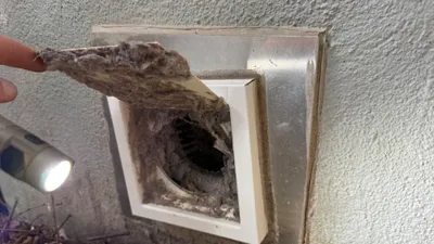 Heavy lint on a dryer vent cover flapper after a year of use in New Irving Park