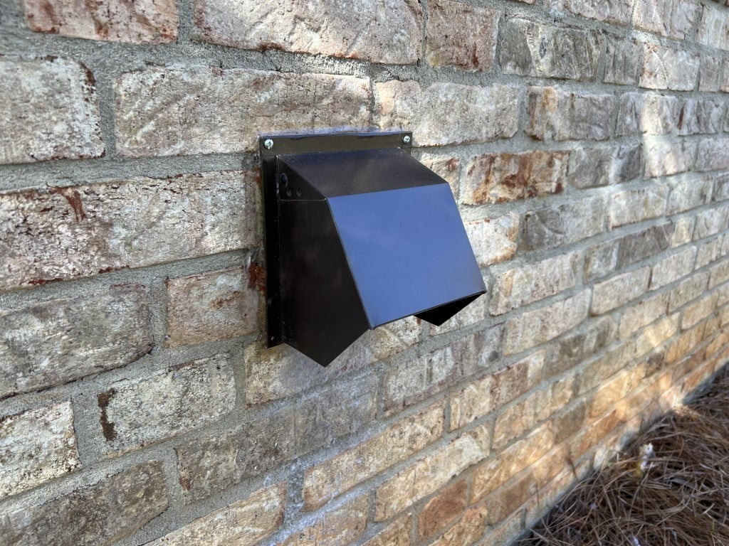 Powder-coated metal dryer vent hood on home exterior