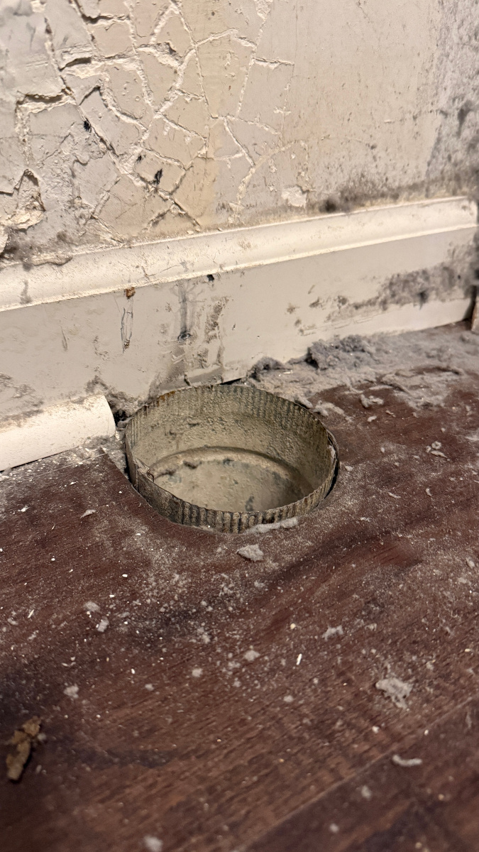 Dryer vent pipe cut too short at floor causing dust and lint leakage