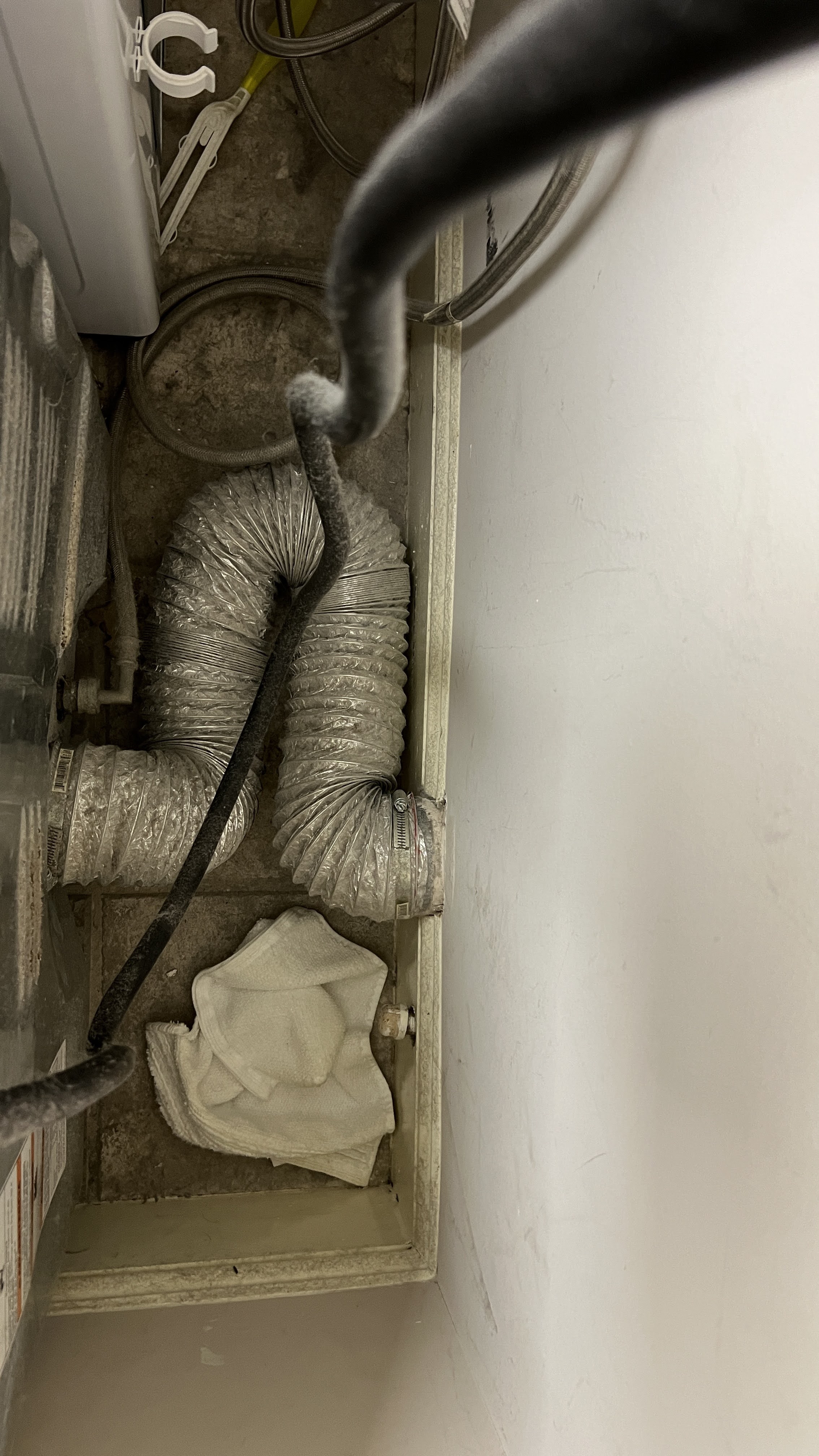 Poorly routed flexible dryer transition hose with dust behind the dryer