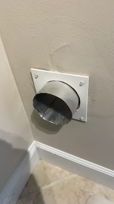 Metal dryer vent stub after we cut away the damaged end in Sunset Hills