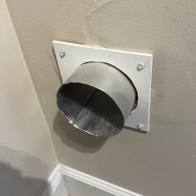 Metal dryer vent stub after we cut away the damaged end in Sunset Hills