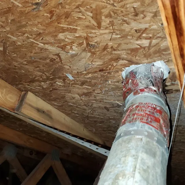 Repaired dryer vent termination in attic with mastic seal