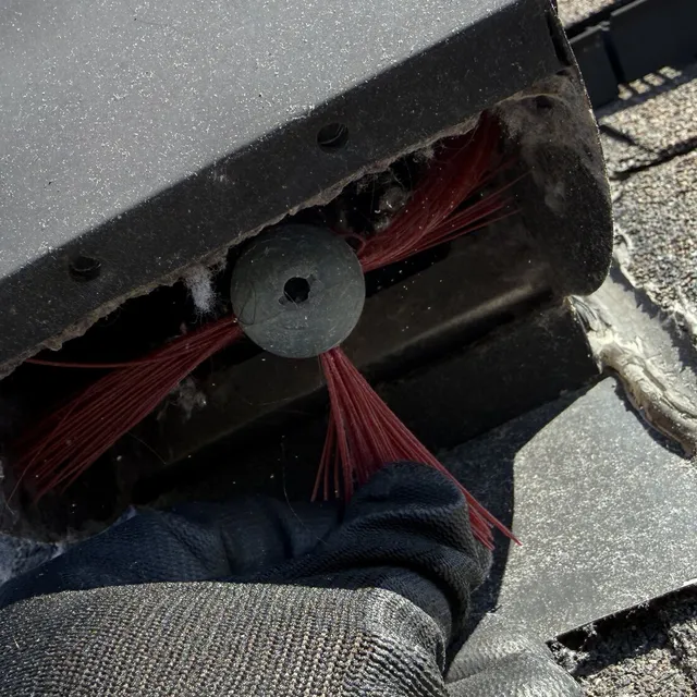 Dryer vent cleaning brush coming out of a roof vent cover in Mackintosh on the Lake Burlington