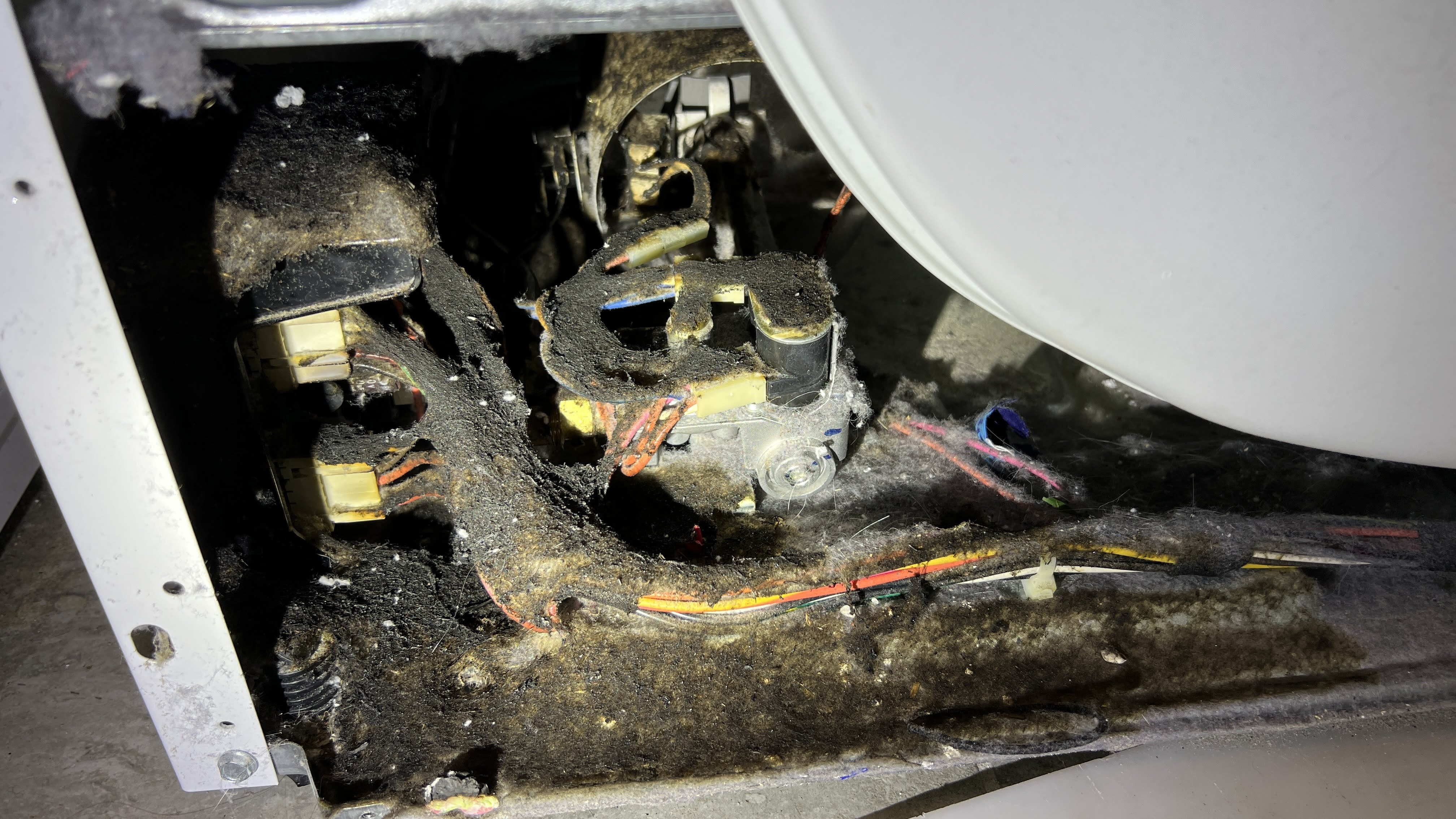 Lint fire damage inside a Speed Queen dryer cabinet