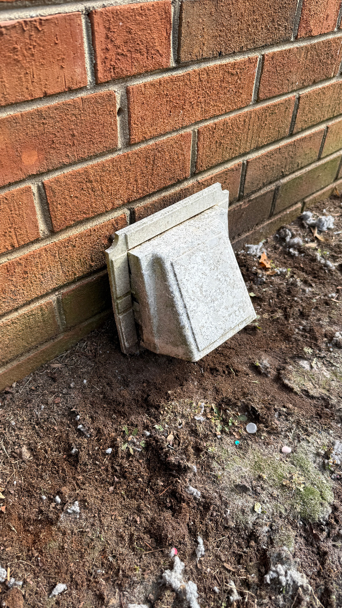 Down-blow vent cover too close to ground causing back pressure and lint buildup