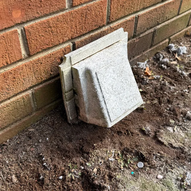 Down-blow vent cover too close to ground causing back pressure and lint buildup