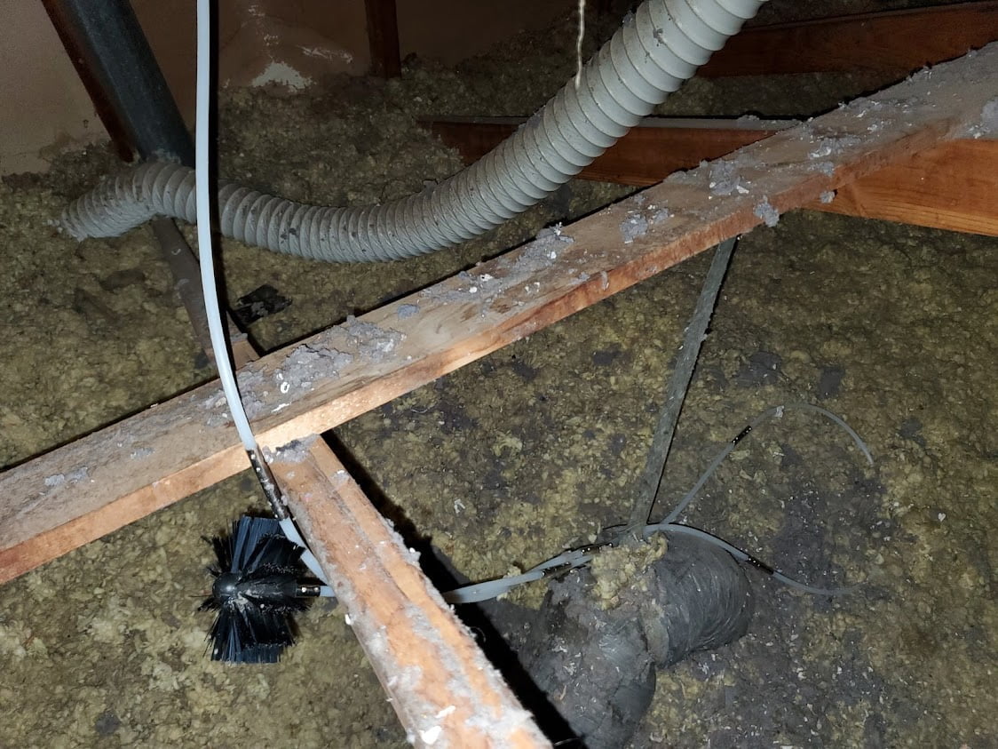 Lint eater brush stuck in attic